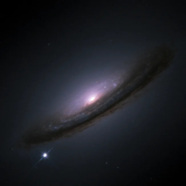 Hubble image of the galaxy NGC 4526 with the Type Ia supernova SN 1994D visible as a bright point at the lower-left edge