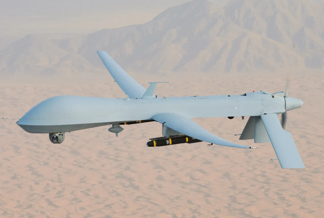 Kanatlarının altında iki füze taşıyan MQ-1 Predator insansız hava aracının uçuş halindeki fotoğrafı