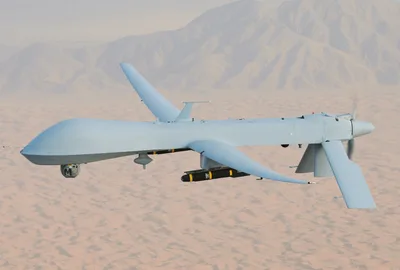 An MQ-1 Predator unmanned aircraft in flight, carrying two missiles under its wings