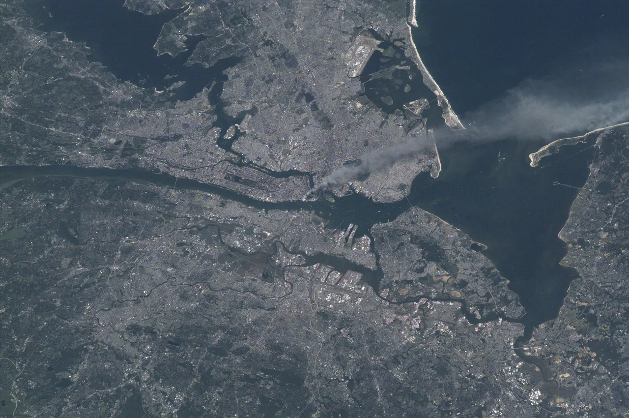 Photograph taken from the International Space Station on 11 September 2001: a long plume of smoke rising from the southern tip of Manhattan drifts out over the Atlantic