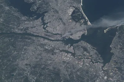 Photograph taken from the International Space Station on 11 September 2001: a long plume of smoke rising from the southern tip of Manhattan drifts out over the Atlantic