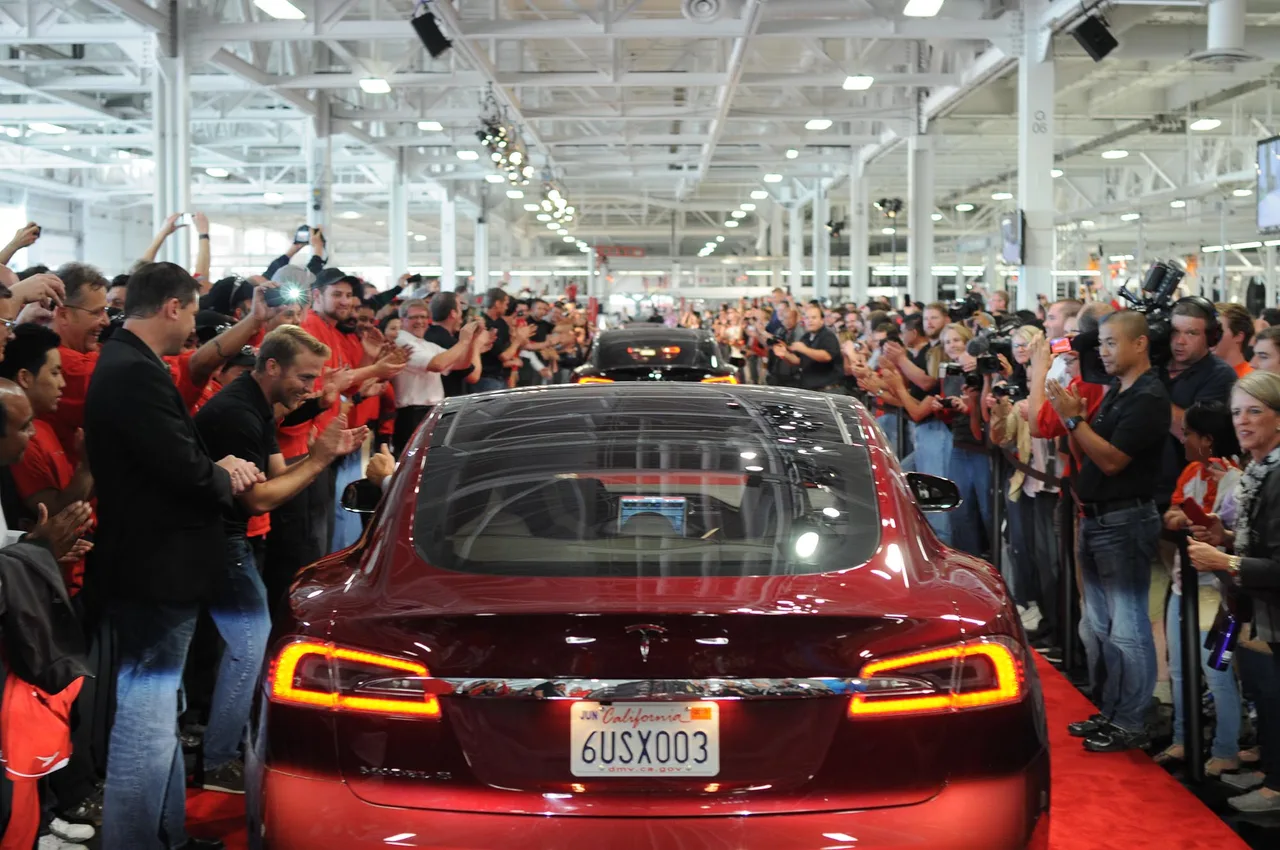 Parade of red Tesla Model S sedans lined up for the first customer deliveries at the Tesla factory in Fremont on 22 June 2012