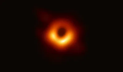 A bright orange-gold ring with a dark black region at its centre: the Event Horizon Telescope's image of the supermassive black hole at the centre of M87