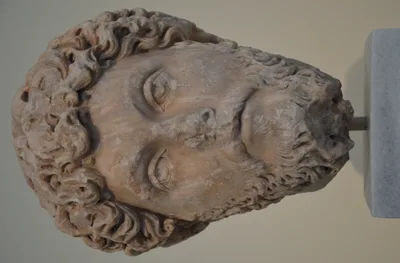 Marble portrait head of Marcus Aurelius — curly hair, full beard, weary expression; found in Athens, now in the National Archaeological Museum of Athens