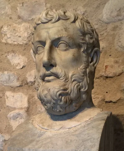 A weathered ancient marble bust of a bearded man at the Velia (Elea) Archaeological Park, identified as Parmenides