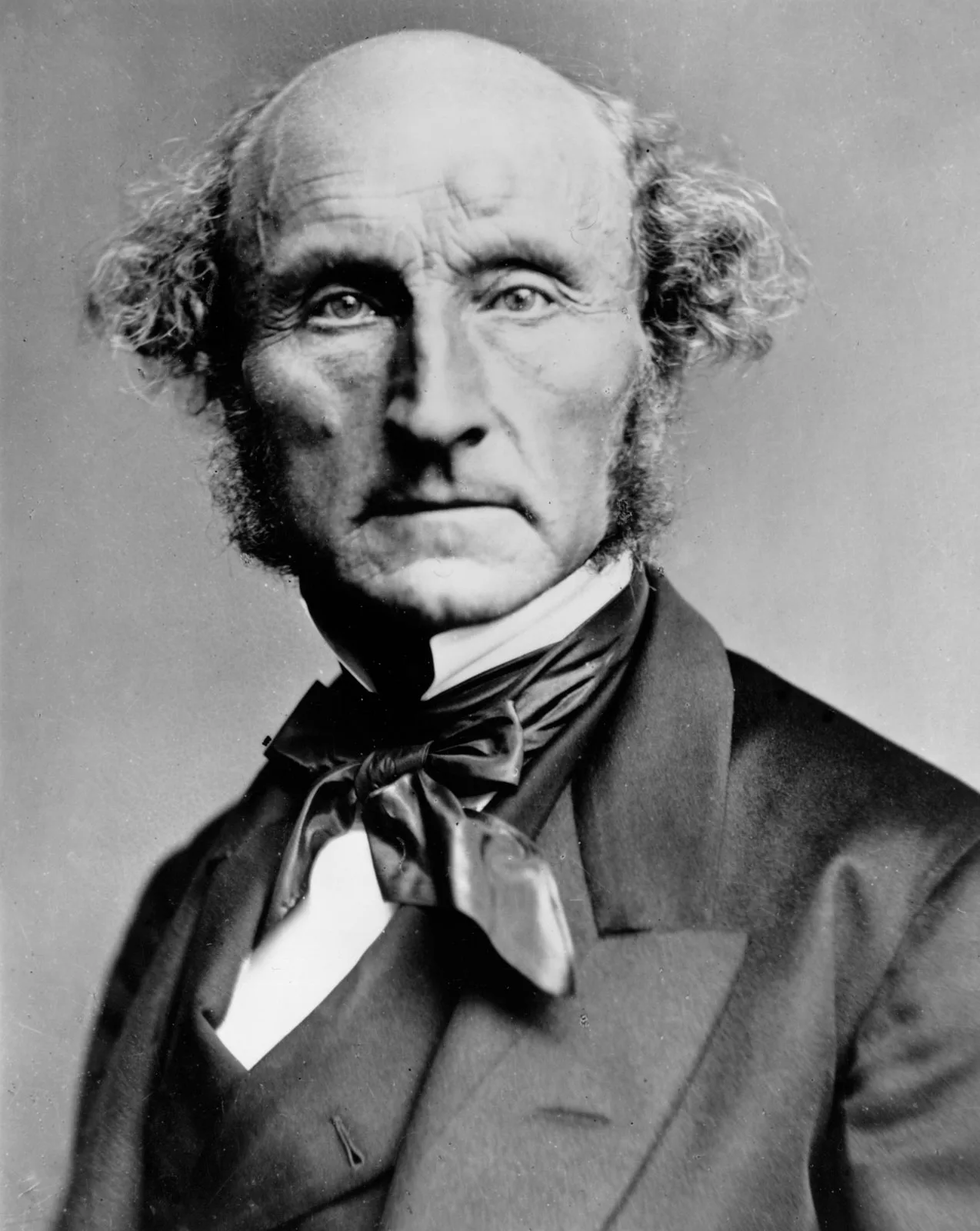Photograph of John Stuart Mill, c. 1870: an elderly man with a calm face and thin white whiskers