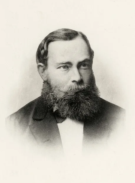 Sepia-toned black-and-white photograph of a young Gottlob Frege in a dark jacket, with beard and a serious gaze, taken around 1879