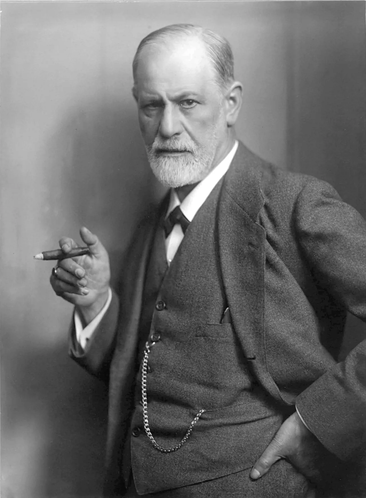 Classic portrait photograph of Sigmund Freud (Max Halberstadt, 1921): bearded, in a suit, holding a cigar