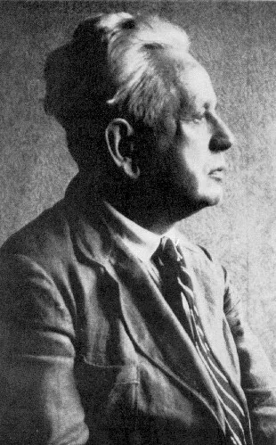 An early-twentieth-century portrait of Ernst Cassirer: a German philosopher with round glasses, short hair, and a suit