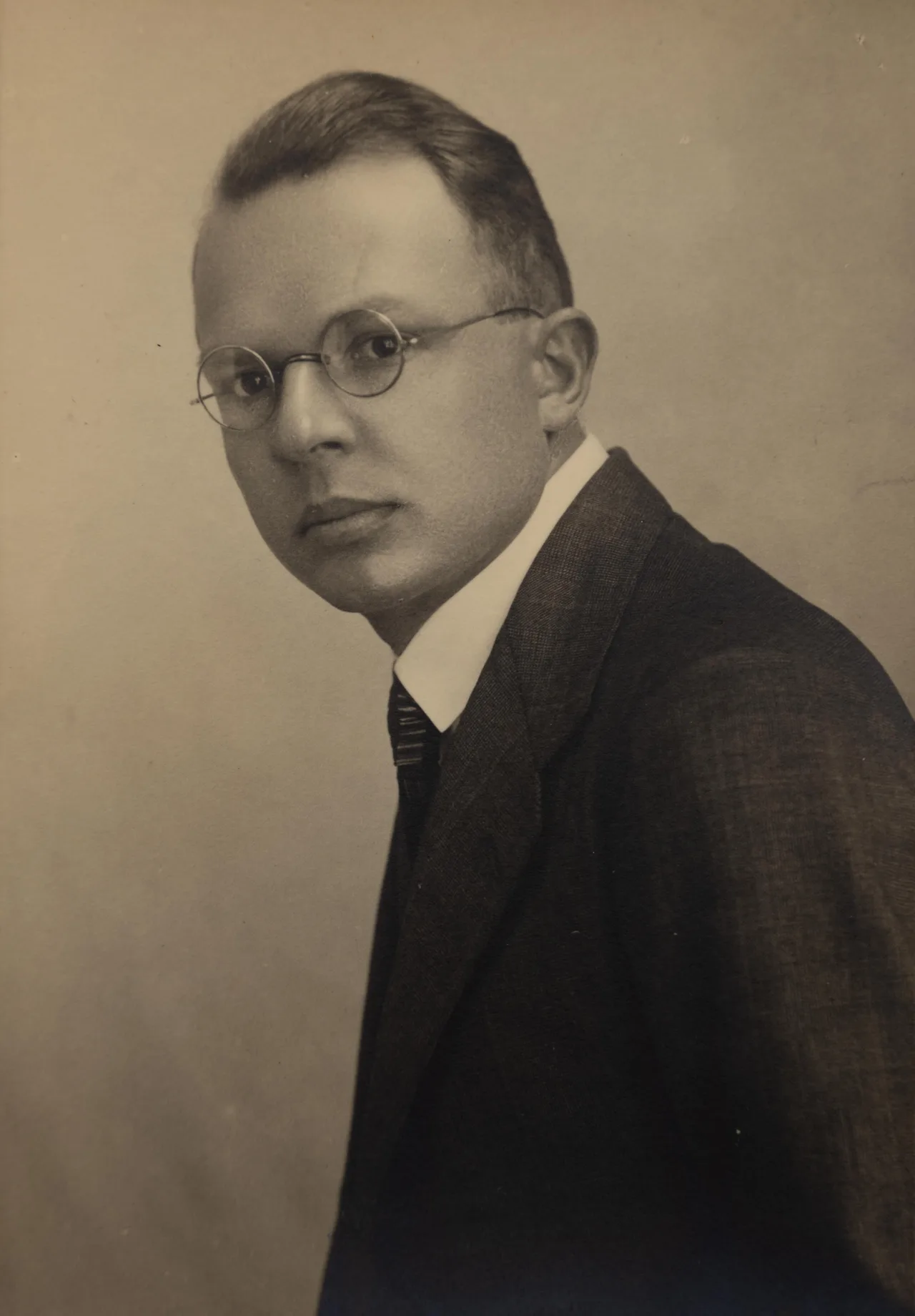 A 1930 black-and-white half-profile portrait of the young philosopher Rudolf Carnap, with glasses and a serious gaze