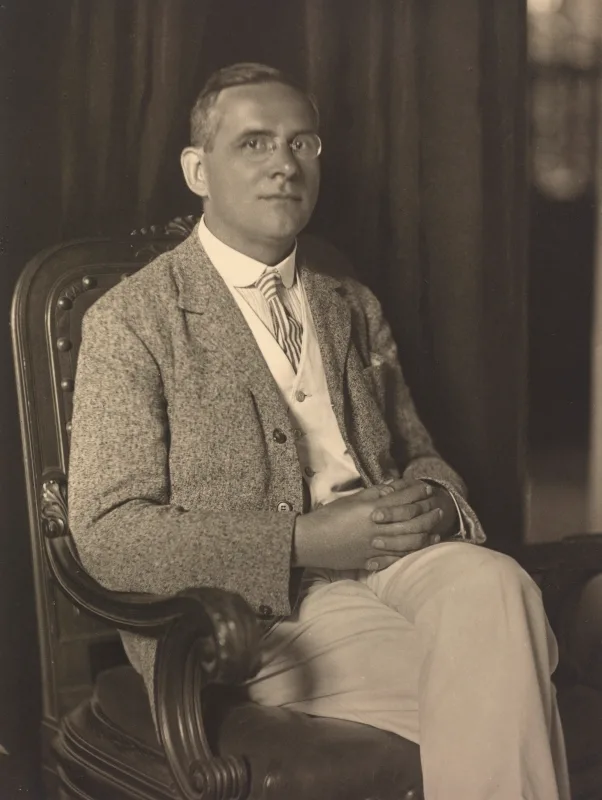 A seated middle-aged man in a suit with a thick moustache — a black-and-white studio photograph of the physicist Moritz Schlick