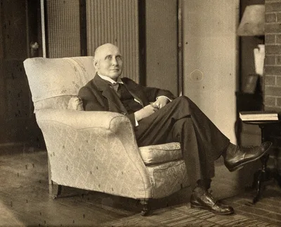 Black-and-white portrait of Alfred North Whitehead: an elderly man in a suit and glasses